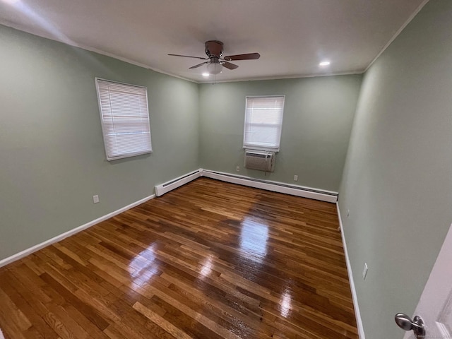 unfurnished room featuring hardwood / wood-style flooring, ceiling fan, baseboards, and crown molding