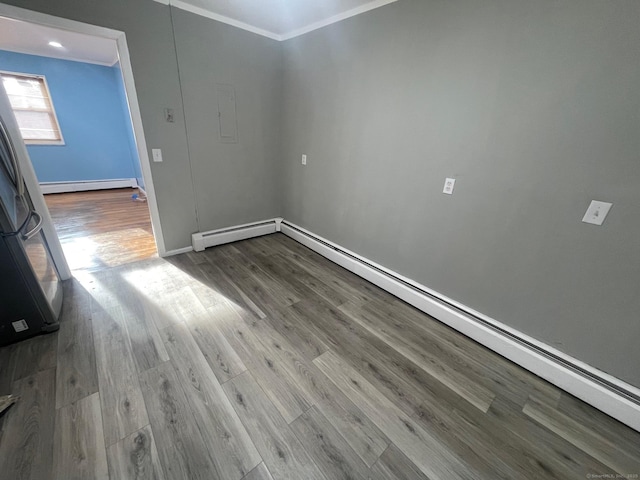 interior space featuring a baseboard radiator, ornamental molding, and wood finished floors