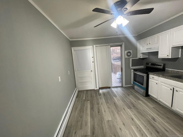 kitchen with dark countertops, light wood-style flooring, ornamental molding, stainless steel range with electric cooktop, and under cabinet range hood