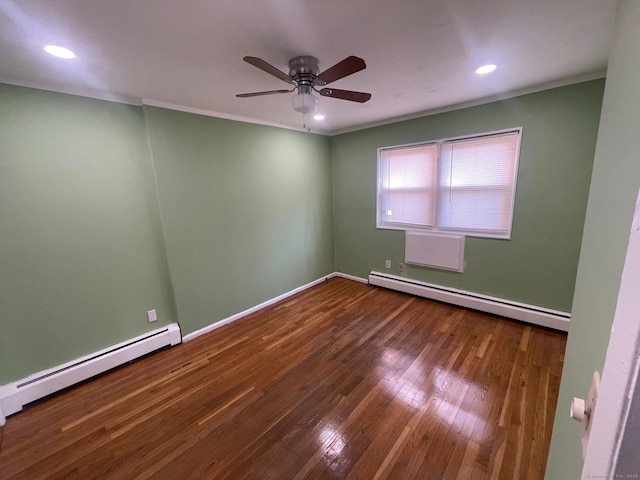 spare room with a baseboard radiator, ornamental molding, wood-type flooring, and baseboards