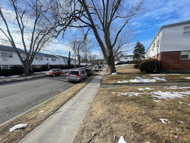 view of road featuring sidewalks and a residential view