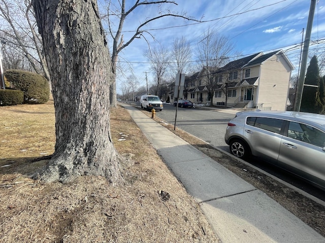 view of road with sidewalks and a residential view