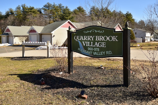 community / neighborhood sign with an attached garage