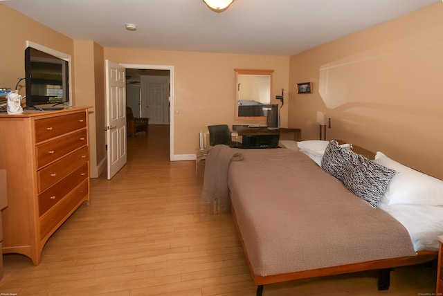 bedroom featuring light wood-type flooring and baseboards