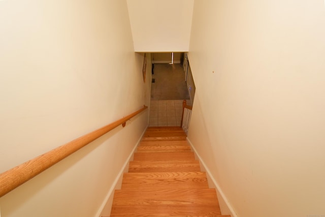 stairs featuring baseboards and wood finished floors