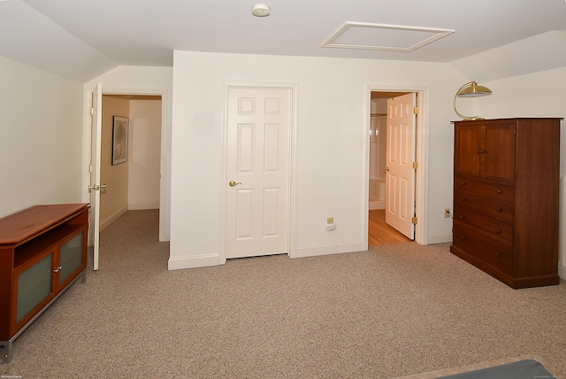 unfurnished bedroom with vaulted ceiling, carpet flooring, and baseboards