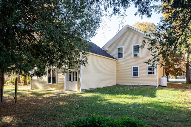 back of property featuring a lawn