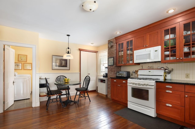 kitchen featuring separate washer and dryer, white appliances, dark wood-type flooring, dark countertops, and glass insert cabinets