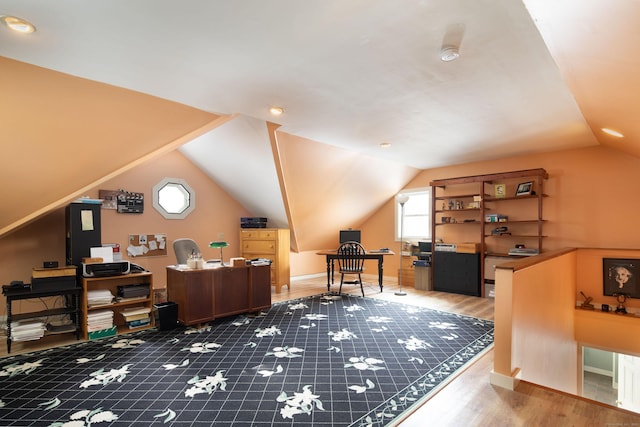 home office featuring lofted ceiling, wood finished floors, and baseboards