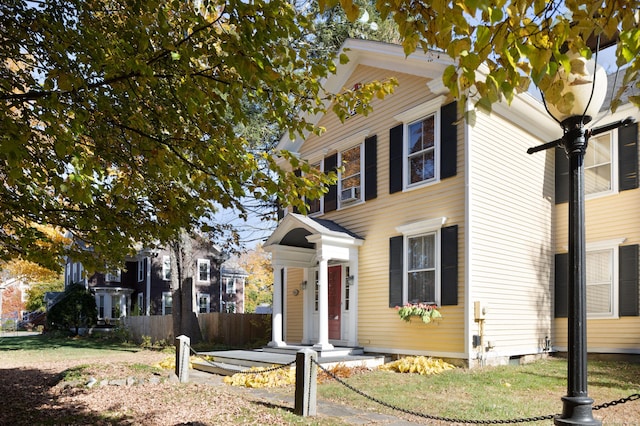 view of front of property featuring crawl space and fence