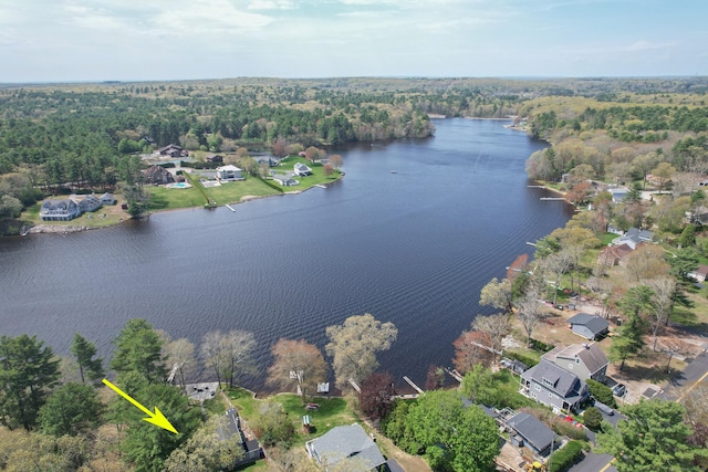 drone / aerial view featuring a water view and a forest view