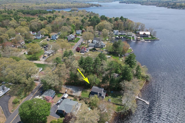 drone / aerial view featuring a residential view, a view of trees, and a water view