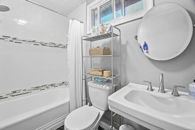 full bathroom featuring shower / bath combo, a sink, and toilet