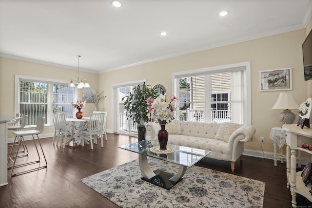 living area with dark wood-style floors, ornamental molding, and a healthy amount of sunlight