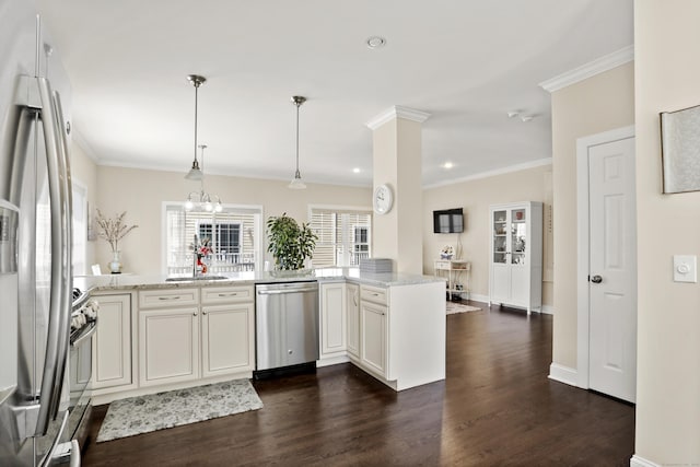 kitchen featuring dark wood-style flooring, a sink, ornamental molding, appliances with stainless steel finishes, and light stone countertops