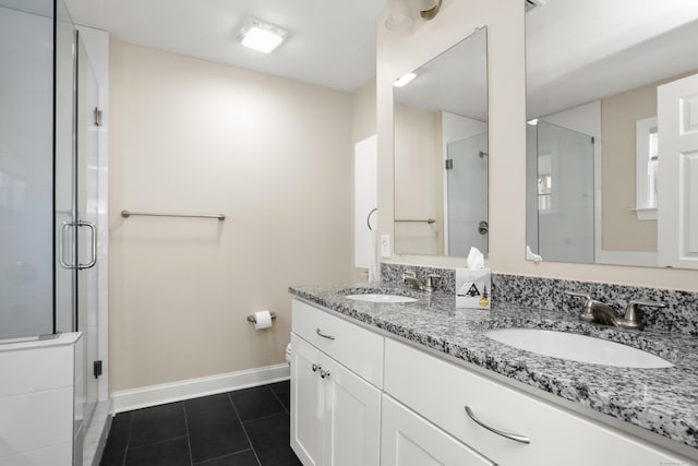 full bathroom featuring a sink, a shower stall, and tile patterned floors