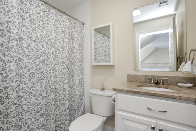 bathroom with toilet, visible vents, a shower with shower curtain, and vanity