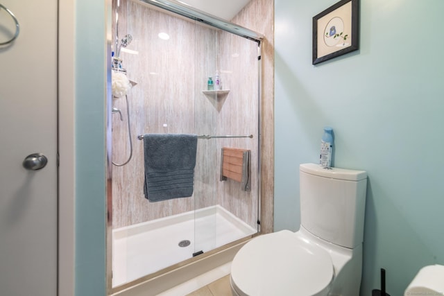 bathroom with toilet and a stall shower