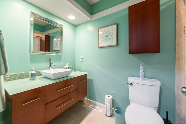 full bathroom featuring baseboards, visible vents, toilet, tile patterned floors, and vanity