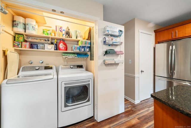 laundry area featuring dark wood-style flooring and washing machine and clothes dryer