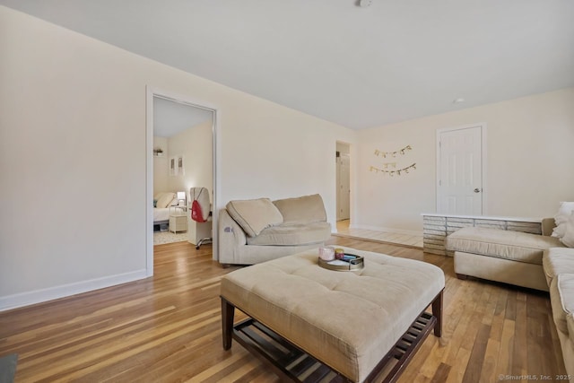 living area with light wood-style flooring and baseboards