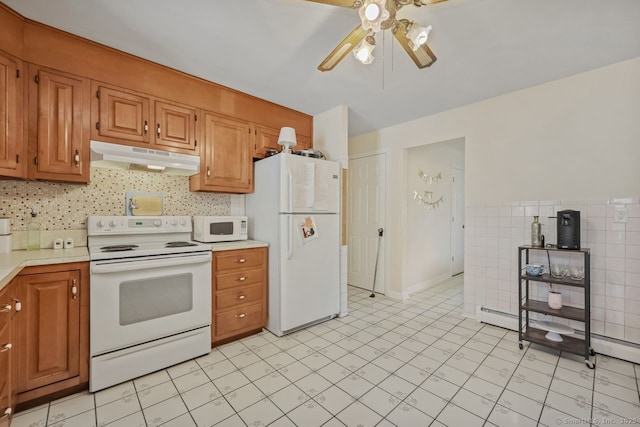 kitchen with white appliances, light countertops, ceiling fan, and under cabinet range hood