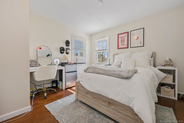 bedroom featuring wood finished floors and baseboards