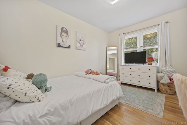 bedroom featuring wood finished floors