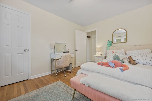 bedroom with wood finished floors and baseboards