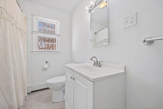 full bathroom featuring toilet, vanity, and baseboard heating