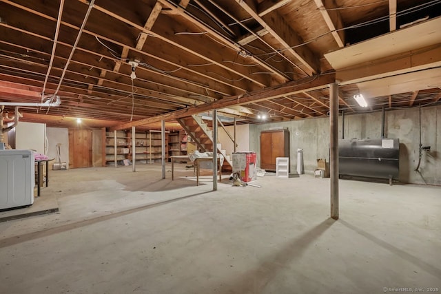 unfinished basement with heating fuel and washer / clothes dryer