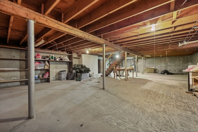 unfinished basement featuring stairway