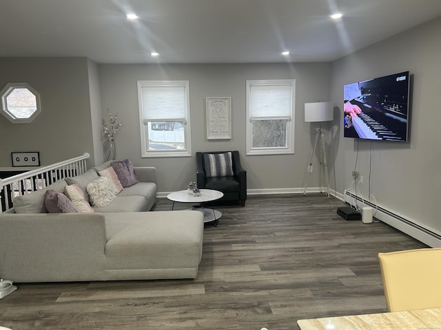 living room with plenty of natural light, a baseboard heating unit, wood finished floors, and recessed lighting