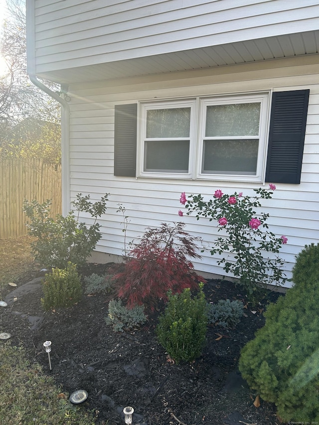 view of home's exterior featuring fence