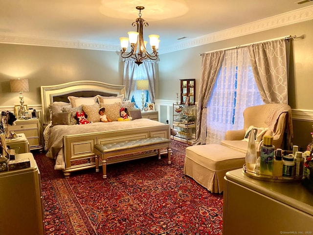 carpeted bedroom featuring an inviting chandelier, visible vents, ornamental molding, and wainscoting