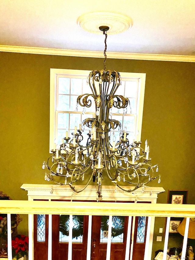 details with an inviting chandelier and crown molding