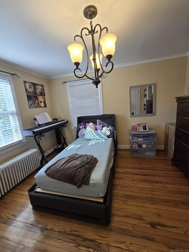 bedroom with radiator, hardwood / wood-style flooring, crown molding, and an inviting chandelier