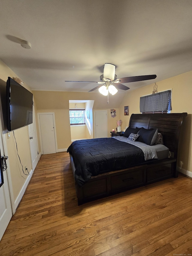 bedroom featuring baseboards, a ceiling fan, and wood finished floors