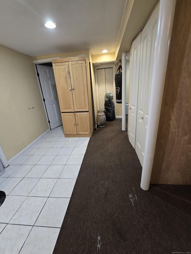 spare room featuring recessed lighting, light colored carpet, baseboards, and light tile patterned floors