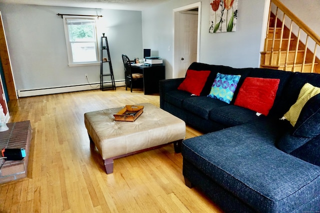 living room with a baseboard heating unit, stairway, and wood finished floors