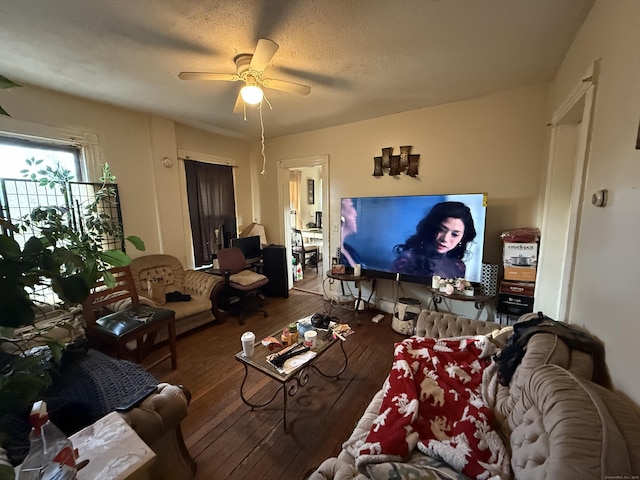 living room featuring a textured ceiling, hardwood / wood-style flooring, and a ceiling fan