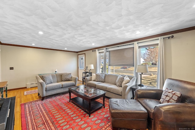 living area with crown molding, recessed lighting, a baseboard heating unit, and light wood-style flooring