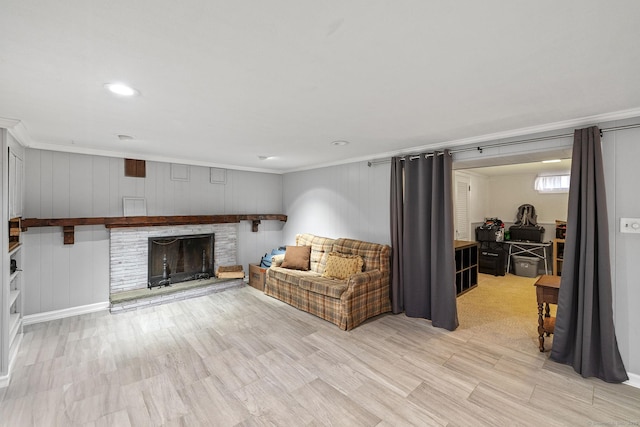living room featuring crown molding and a fireplace
