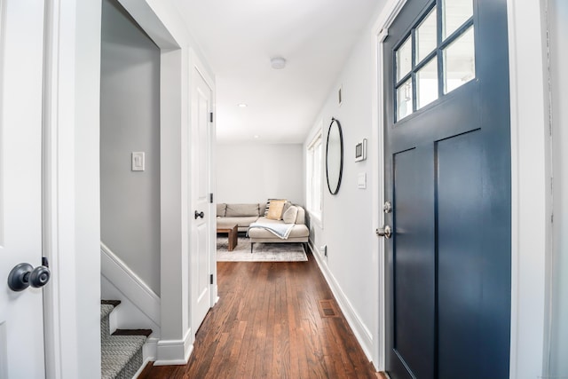 interior space with visible vents, stairs, baseboards, and dark wood-type flooring