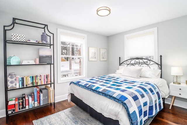 bedroom featuring wood finished floors and baseboards