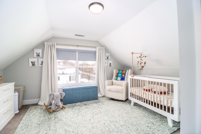 carpeted bedroom featuring a nursery area, visible vents, baseboards, and vaulted ceiling