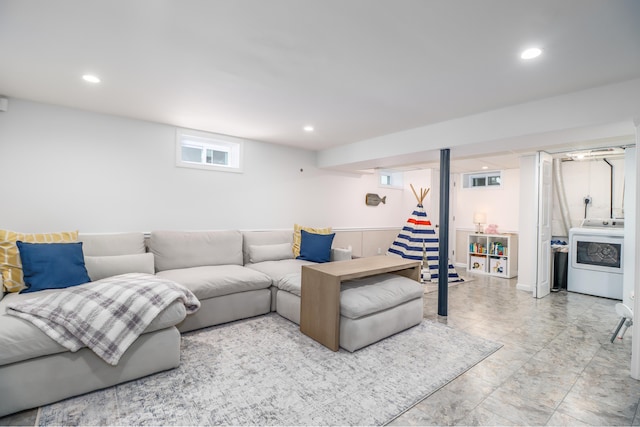 living room featuring washer / clothes dryer and recessed lighting