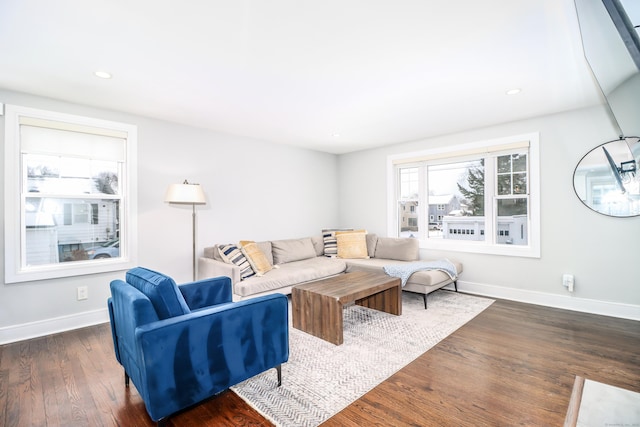 living area featuring recessed lighting, baseboards, and wood finished floors