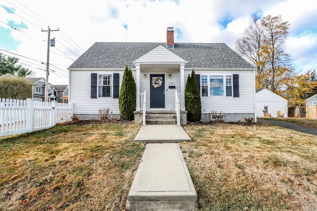 bungalow-style house featuring a shingled roof, a chimney, a front yard, and fence