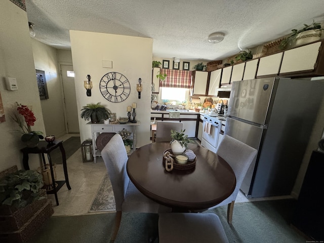 dining space featuring a textured ceiling